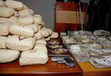 Trump Goes After Sinaloa CARTEL Cash Seized packages, cash, and handguns on a table