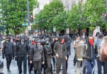 Teacher BLAMES Somali Parents for Troubled Kids group of masked protesters walking through a city street