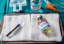 Medical tray with syringe and pentobarbital vials on gauze
