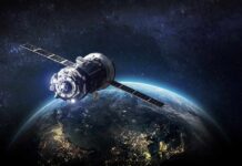Satellite orbiting Earth over night side
