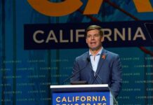 Eric Swalwell speaks at a podium during a California Democrats event