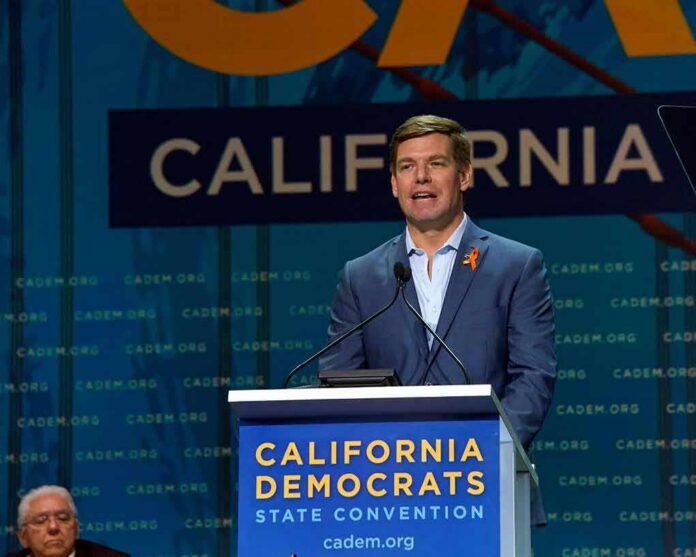 shutterstock_1414003526 Eric Swalwell speaks at a podium during a California Democrats event