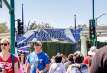 Body Found Outside DISNEYLAND Crowd walking past a Disneyland Resort entrance sign