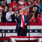 Trump Walks Onstage to WILD Reception Donald Trump points from a rally stage; Rudi Koertzen and Bear Pascoe are in the crowd