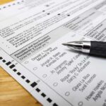 Judge BLOCKS Citizenship Checks on Voter Rolls Ballot paper with pen on wooden surface