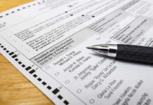 Judge BLOCKS Citizenship Checks on Voter Rolls Ballot paper with pen on wooden surface