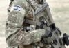 soldier in camouflage holding a rifle