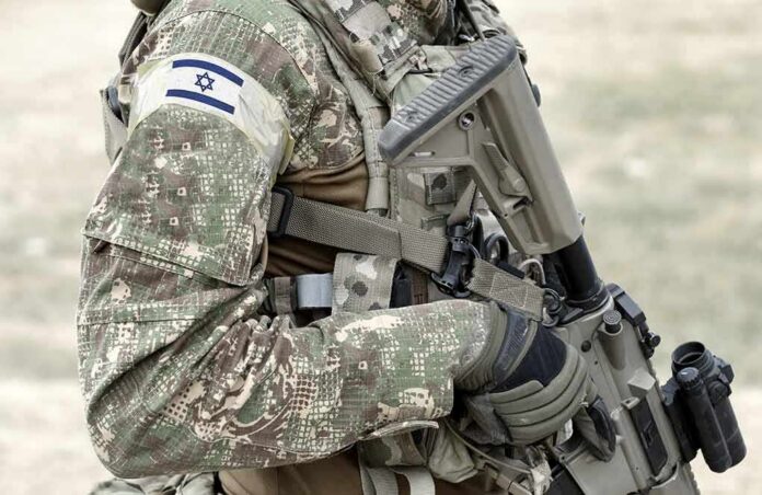 shutterstock_1917131027 soldier in camouflage holding a rifle