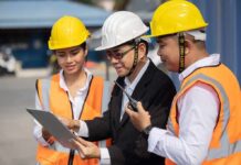 Four-Hour Bus Ordeal Exposes DOE Chaos Construction team reviewing a tablet on site