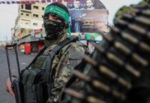Muslim Brotherhood Question RATTLES Democrat Senate Hopeful armed person in camouflage with face covering on a city street