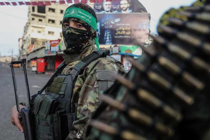 armed person in camouflage with face covering on a city street