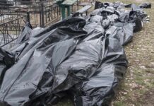 NAACP Wants Hanging Halloween BODIES Gone Black plastic bags piled outdoors near metal fencing