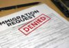 DHS Says 60 Minutes HID Deportee’s Secret Immigration request form with denied stamp on a desk