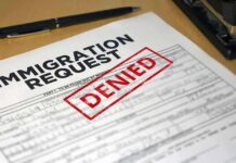 Immigration request form with denied stamp on a desk