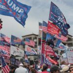 Crowd at political rally with many American and campaign flags