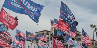 Crowd at political rally with many American and campaign flags