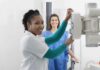 WH Chief of Staff Almost Skipped a Life-Saving TEST Radiologic technologist adjusting X-ray machine with patient standing behind