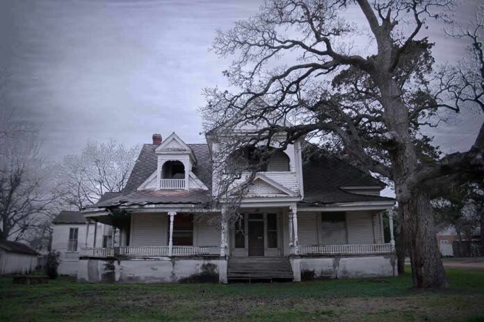 Old abandoned Victorian house with wraparound porch