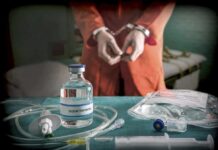 Botched Execution HALTS Tennessee Death Chamber Medical vials and IV lines on a table with a handcuffed person in the background